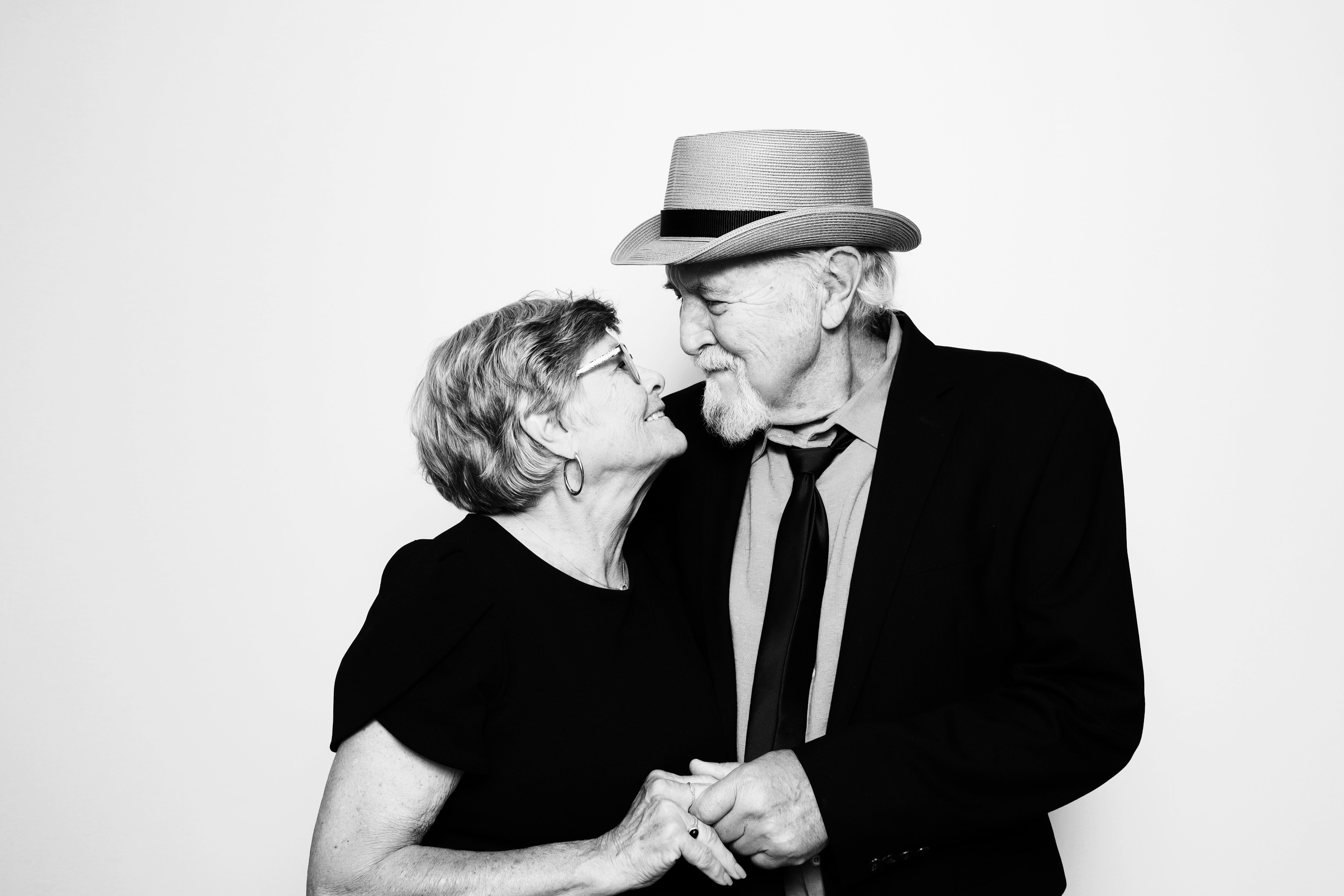 An elderly couple in a tender moment — the marquee photograph for Photobooth of the Carolinas